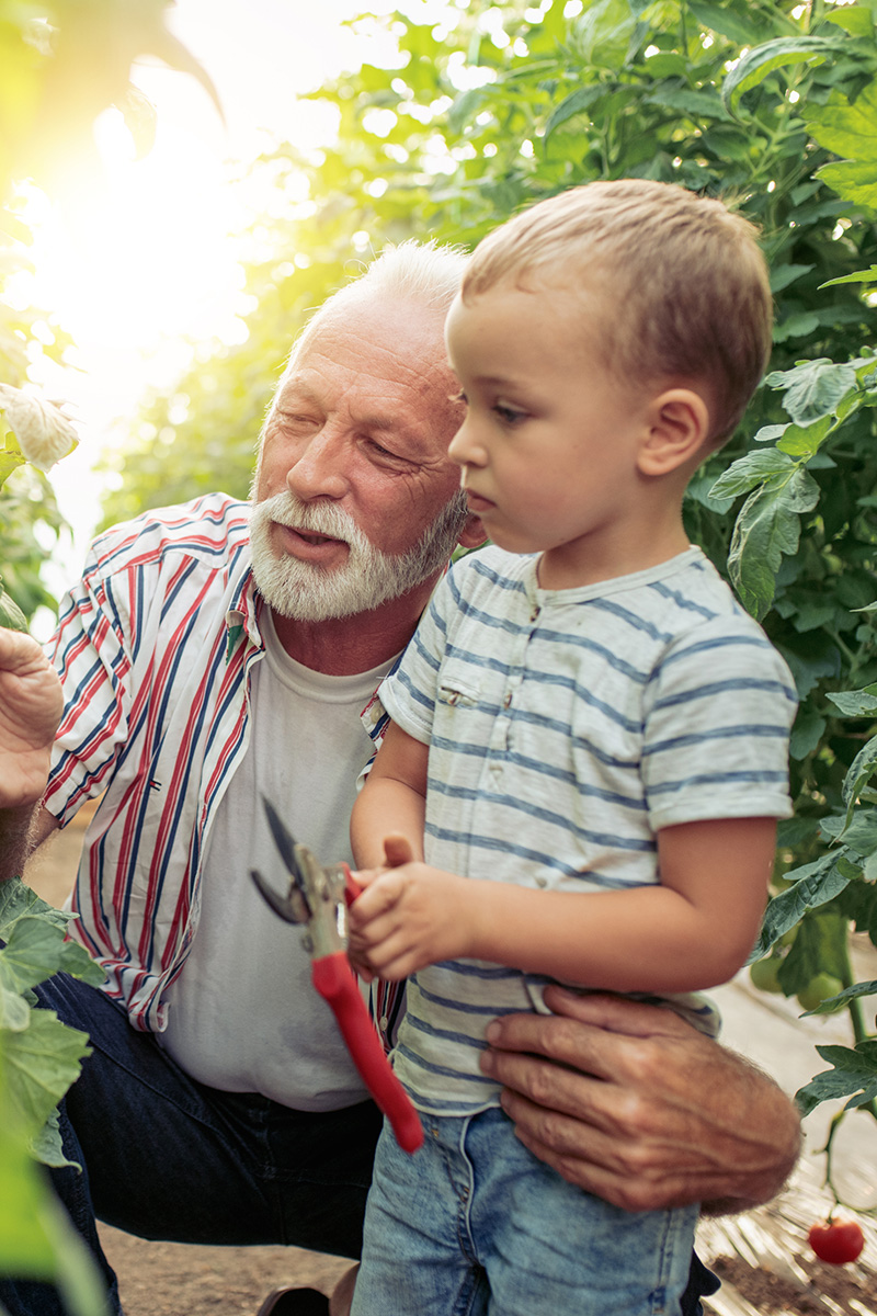 An Allercare patient enjoys gardening with their grandchild